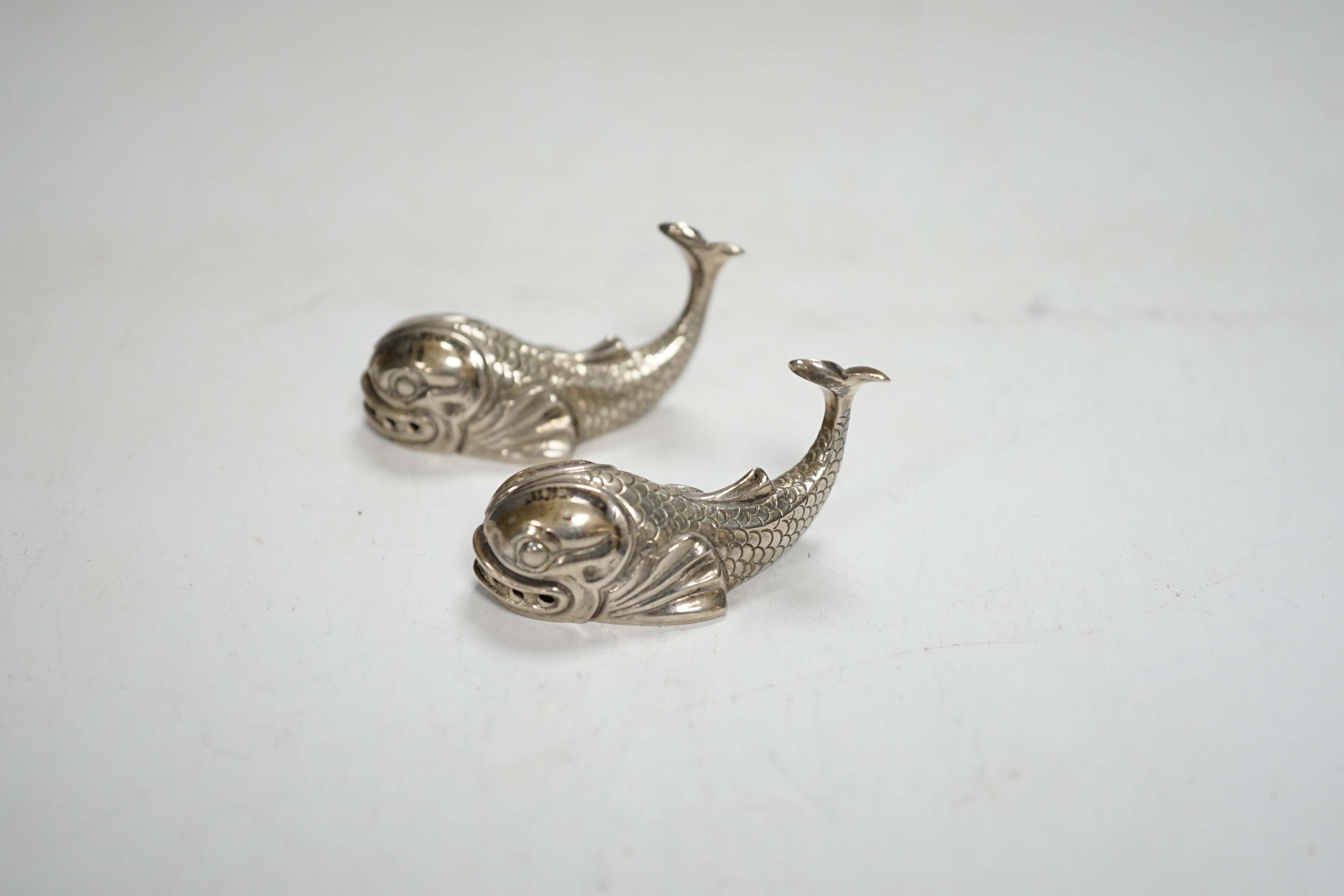 A pair of 20th century Italian Missiaglia 800 standard white metal novelty pepperettes, modelled as fish, length 42mm.